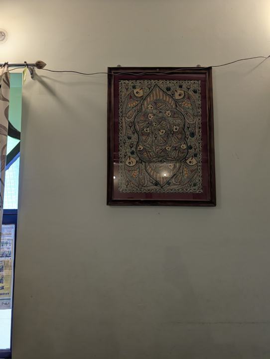 Framed Mithila painting on a wall