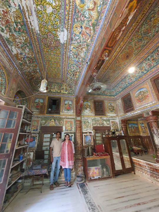 A room with frescoed ceiling and walls